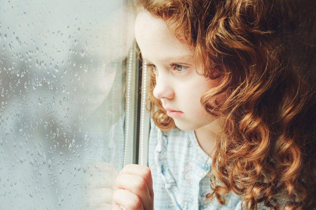 Child looking at a window