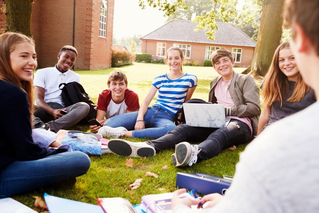Teenage students sitting outdoors