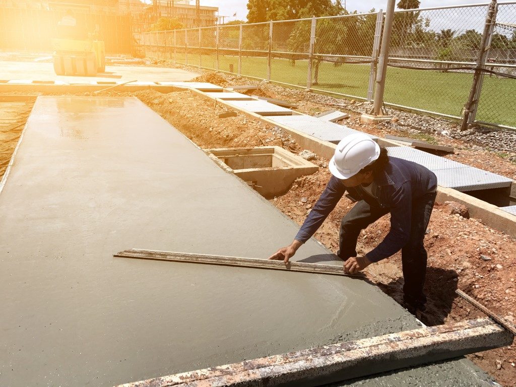 Worker spreading concrete