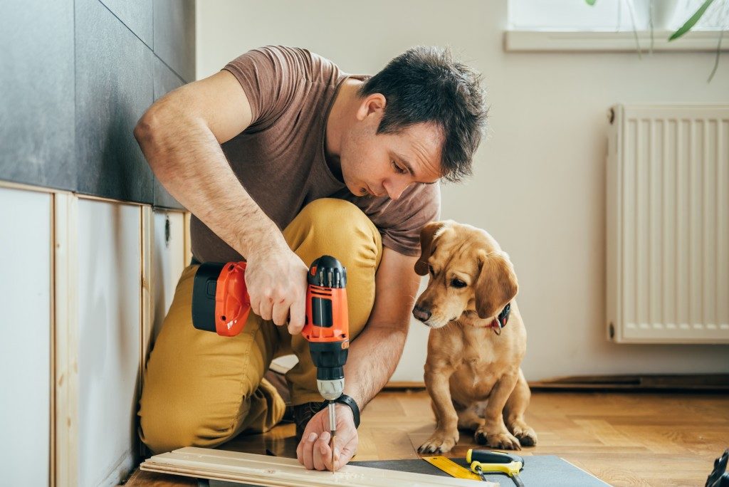 Man building home with his dog