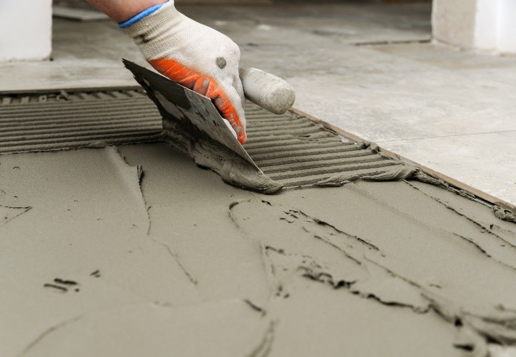 Worker smoothening concrete