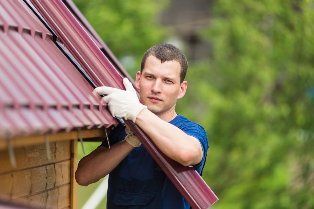 man holding roofing material