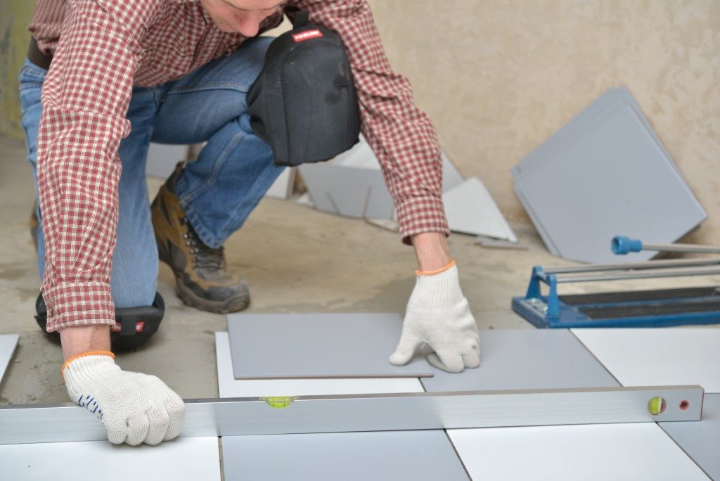placing tiles on the floor