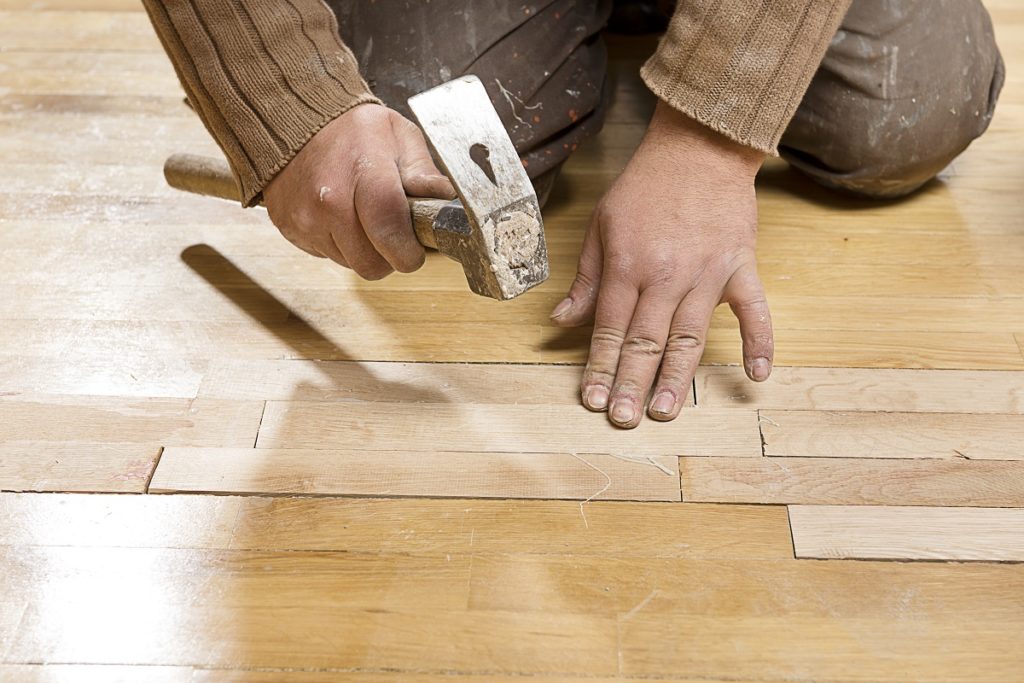 Man assembling hardwood floor