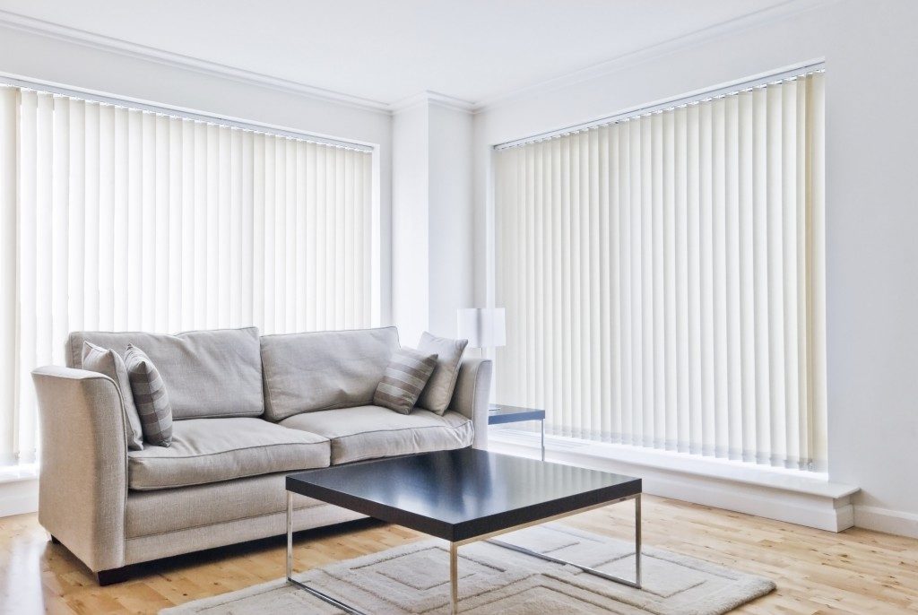 white blinds installed in the living room windows