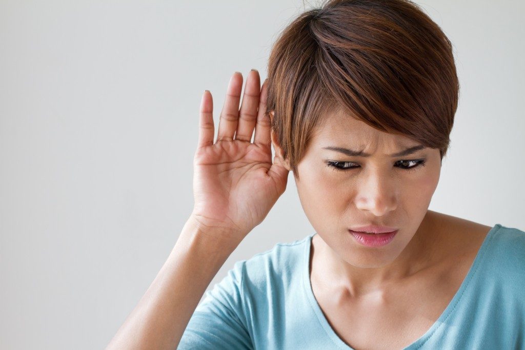 woman suffering from hearing impairment