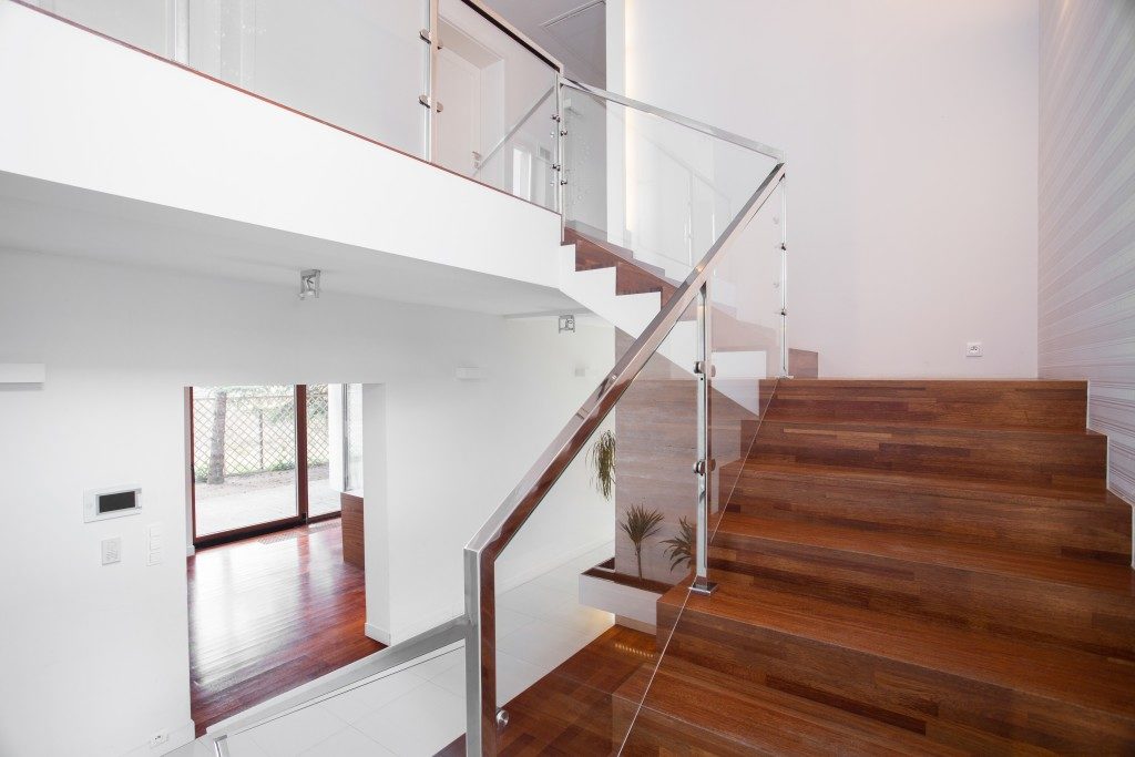 mage of solid wooden stairs with elegant glass balustrade