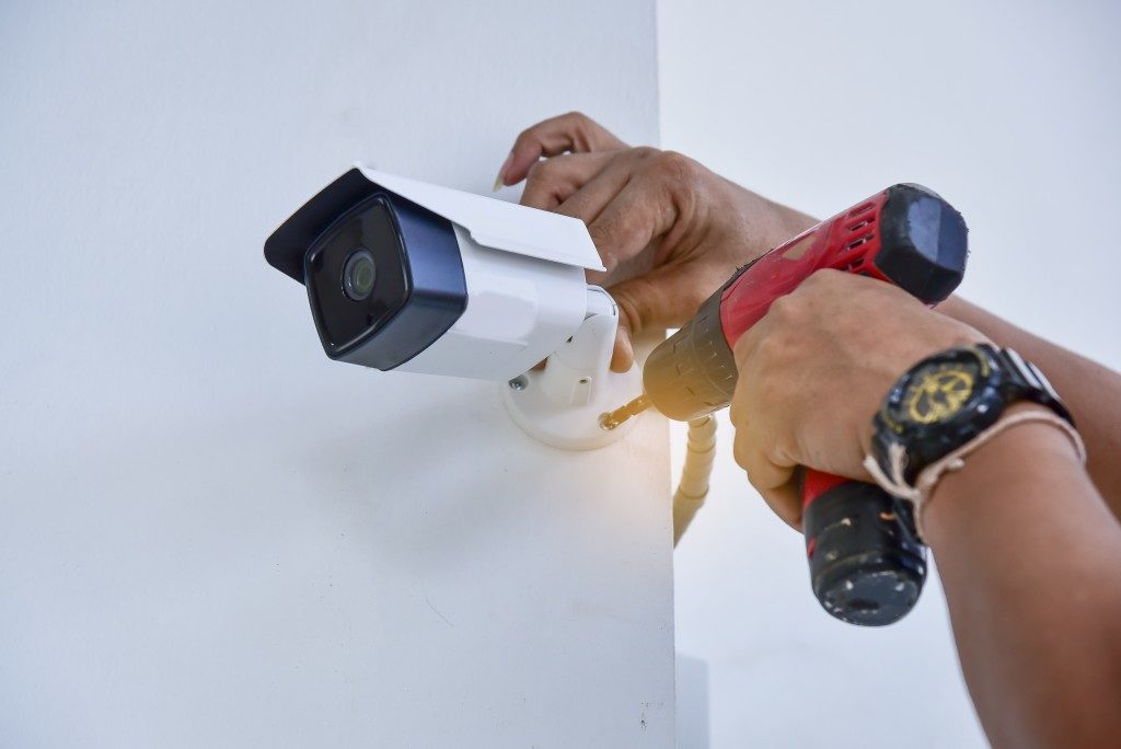 man installing a cctv camera