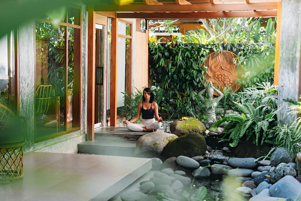 woman doing yoga in a Balinese rock garden