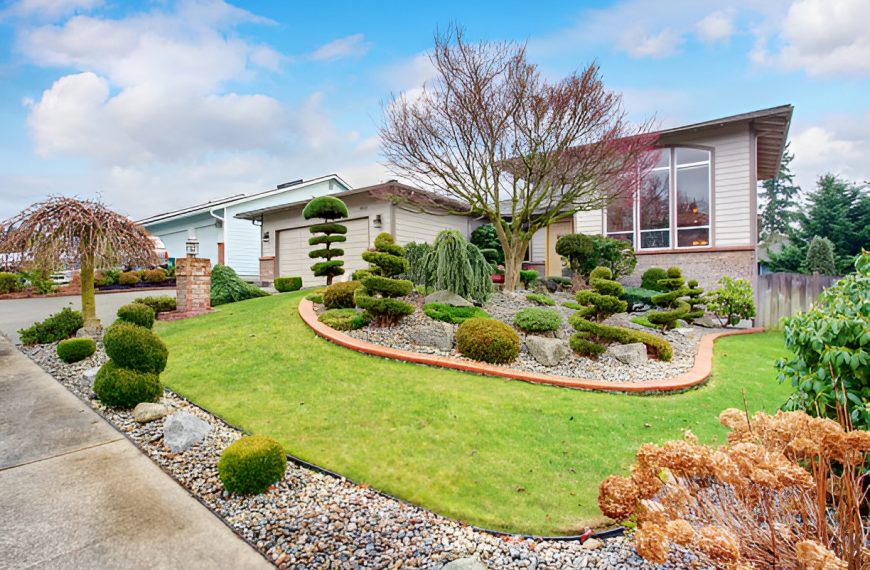 front yard with shrubs, trees, flowers, and rocks